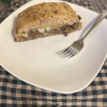Slice of beef and cheese loaf on blue and white checked towel